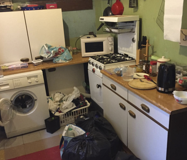 Cluttered kitchen before hoarding clearance