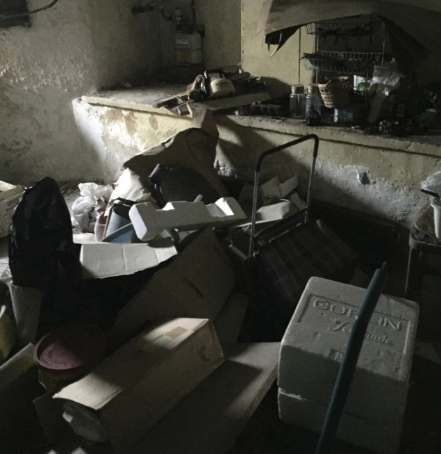 Room packed with boxes and old equipment before clearance