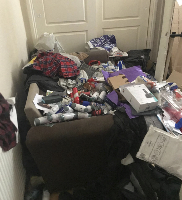 Chair covered in bottles and rubbish before clearance